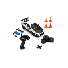 A white and black remote control toy sports car with a black hood, shown with a black handheld transmitter, a blue battery, four black wheels, and four orange traffic cones on a plain white background.