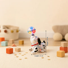 Toy figure with a colorful light-up head on a beige surface with measurement details