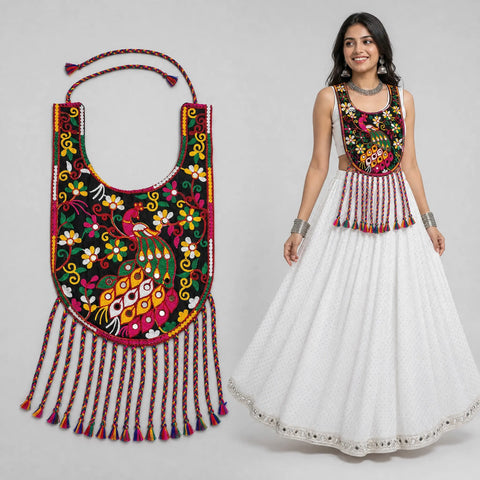 Black | model wearing embroidered multicolor blouse with white skirt