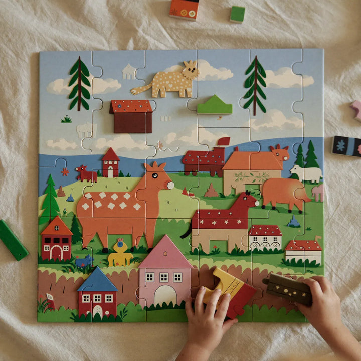 Child completing a chunky wooden farm jigsaw puzzle