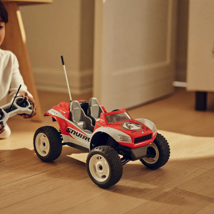 Child playing with a remote-control off-road toy car